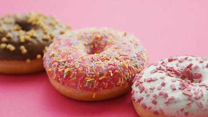 Image showing Row of glazed sweet doughnuts