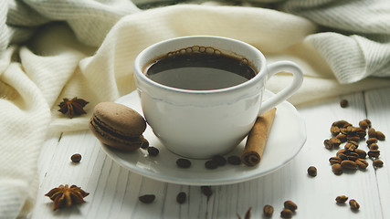 Image showing Cup of coffee with spices and macaron