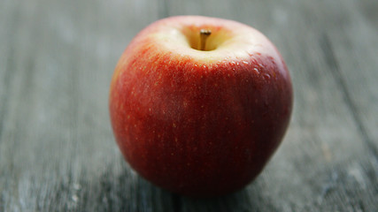 Image showing Ripe red apple on wooden desk