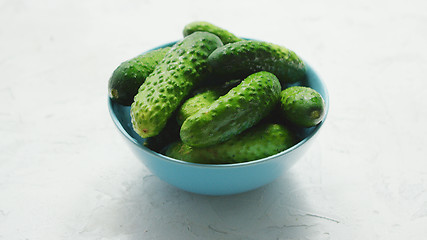 Image showing Bowl of green shiny cucumbers