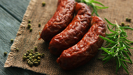 Image showing Rosemary and pepper near whole sausages