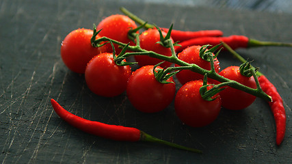 Image showing Wet ripe tomatoes and chili pepper