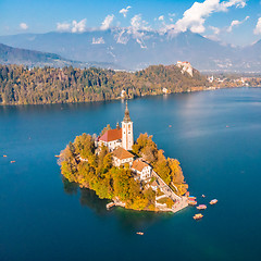 Image showing Aerial view of Bled island on lake Bled, and Bled castle and mountains in background, Slovenia.