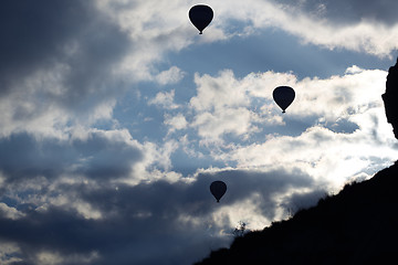 Image showing Silhouettes of the hot air balloons flying