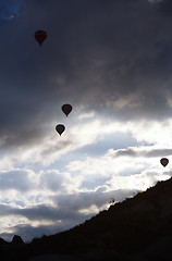 Image showing Silhouettes of the hot air balloons flying