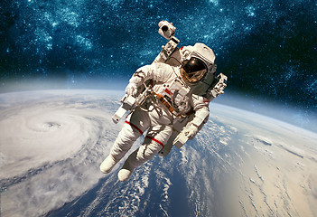 Image showing Astronaut in outer space against the backdrop of the planet eart