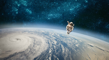 Image showing Astronaut in outer space against the backdrop of the planet eart