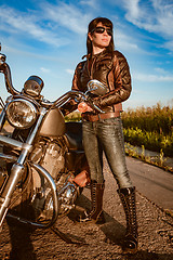 Image showing Biker girl sitting on motorcycle