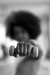 Image showing woman working out in a crossfit gym with dumbbells