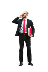 Image showing Happy businessman talking on the phone with folder in hand isolated over white background in studio shooting