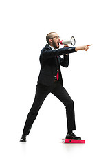 Image showing Side view of a man screaming on the megaphone over white background