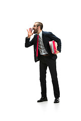 Image showing Do not miss. Young casual man shouting. Shout. Crying emotional man screaming on white studio background