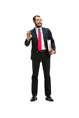 Image showing Happy businessman talking on the phone with folder in hand isolated over white background in studio shooting