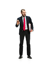 Image showing Angry businessman talking on the phone isolated over white background in studio shooting