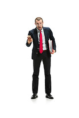 Image showing Surprised businessman talking on the phone isolated over white background in studio