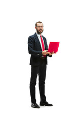 Image showing Picture of handsome young bearded man standing over white studio background with laptop