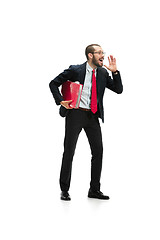 Image showing Do not miss. Young casual man shouting. Shout. Crying emotional man screaming on white studio background