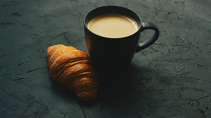 Image showing Cup of coffee and croissant