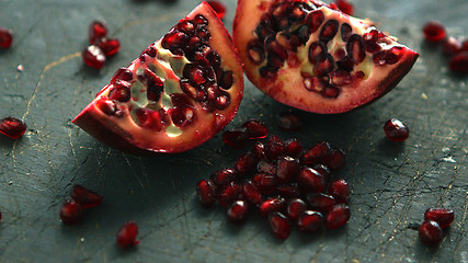 Image showing Ripe pomegranate halves on board