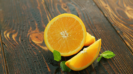 Image showing Ripe cut orange on table 