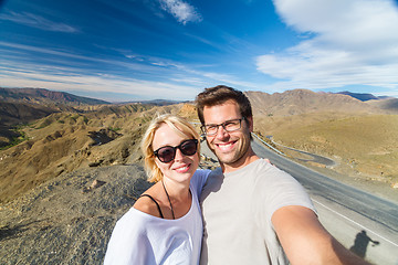 Image showing Active happy couple taking selfie on travel in high Atlas mountains, Ouarzazate, Morocco.