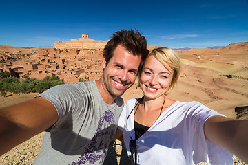 Image showing Active happy couple taking selfie on travel at Ait Benhaddou kasbah, Ouarzazate, Morocco.