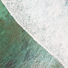 Image showing Aerial shot of the braking wave in the ocean.