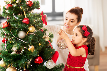 Image showing happy family decorating christmas tree at home