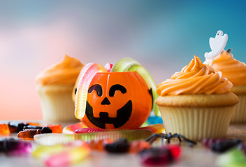 Image showing halloween party decorated cupcakes on wooden table