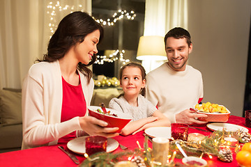 Image showing happy family having christmas dinner at home