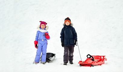 Image showing happy little kids with sleds in winter