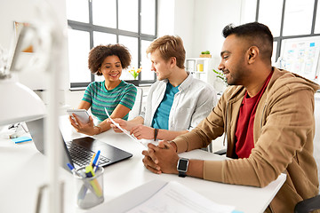 Image showing creative team discussing papers at office