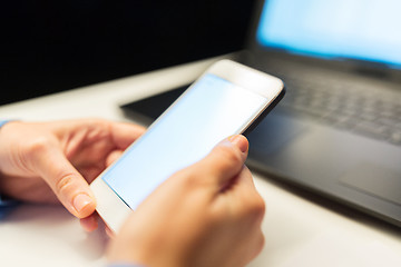 Image showing close up of hands with smartphone at night office