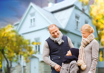 Image showing happy family over living house in autumn