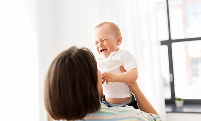 Image showing mother holding crying little baby son at home