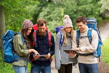 Image showing friends or travelers with backpacks and tablet pc