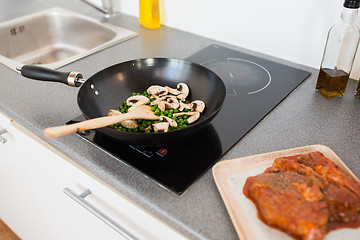 Image showing close up of food in frypan on cooking panel