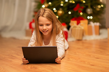 Image showing smiling girl with tablet pc at christmas home