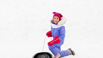 Image showing happy little girl with sled on snow hill in winter