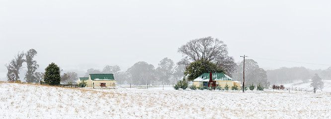 Image showing Farm house and outbuildings in the snowy landscape