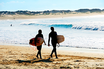 Image showing Silhouette of surfers couple