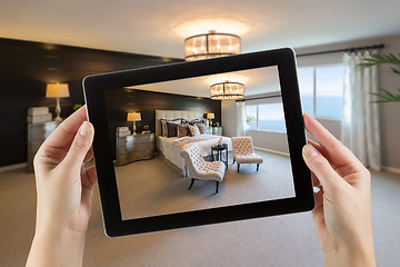 Image showing Female Hands Holding Computer Tablet In Room with Photo on Scree