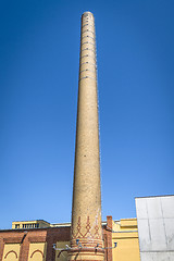 Image showing Tall chimney made of bricks on a factory