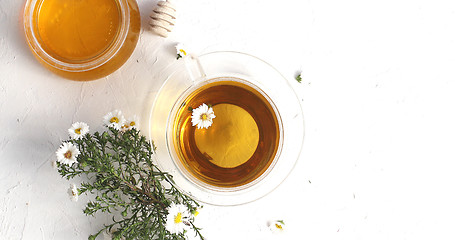 Image showing Cup of tea and bowl of honey