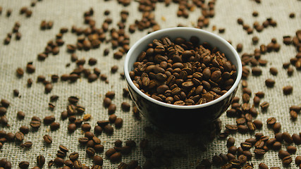 Image showing Cup of coffee beans on canvas