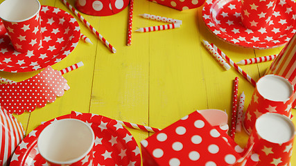 Image showing Festive paper plates and cups laid in circle