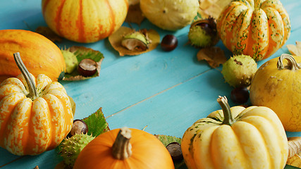 Image showing Pumpkins and chestnuts laid in circle