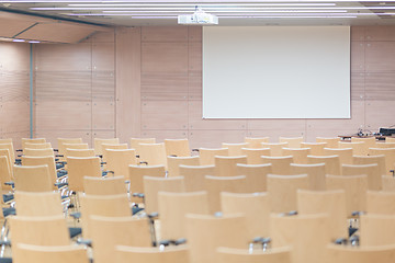 Image showing Empty wooden seats in a cotmporary lecture hall.