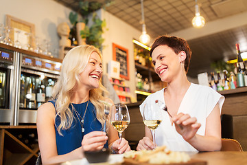 Image showing women eating snacks at wine bar or restaurant