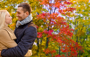 Image showing smiling couple hugging in autumn park